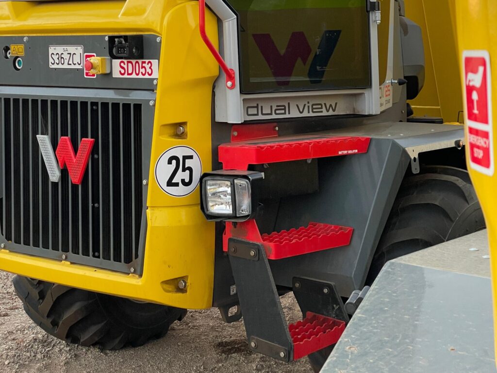 Close up of the Wacker Neuson Dumper Truck with the Dual View text and icon yellow colour body and red steps